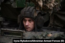 A Ukrainian tank driver speckled with mud at an undisclosed location in October