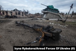 A damaged monument to a World War II battle between Soviet and Nazi forces stands above the wreckage of a modern armored vehicle in the recaptured town of Trostyanka, in Ukraine’s Sumy region, in March.