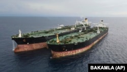 The Iranian-flagged MT Arman 114 (right) and the Cameroon-flagged tanker, MT S Tinos are seen after they were caught conducting an illegal oil transfer near Indonesia. (file photo)