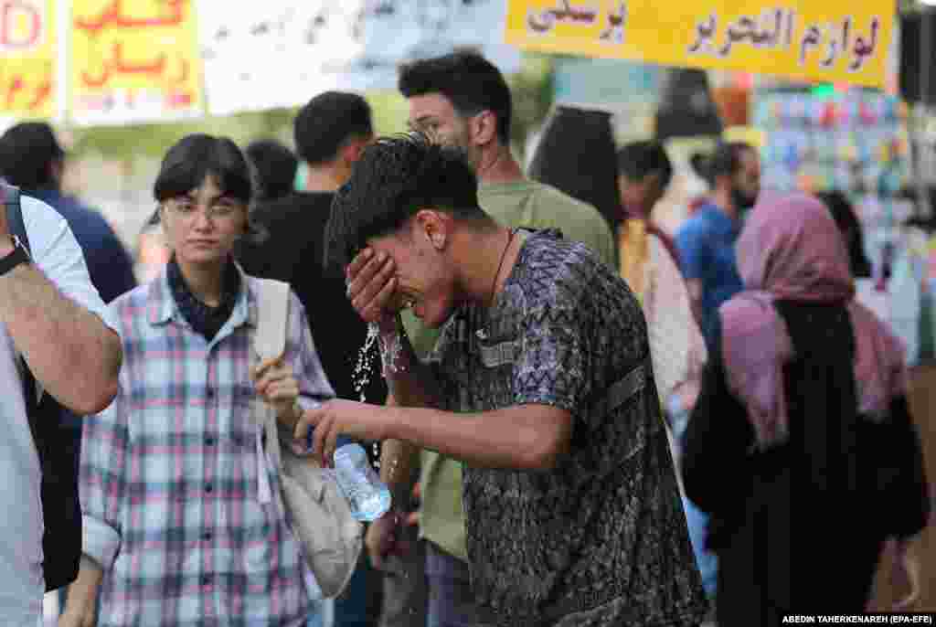 A boy tries to cool off with a bottle of water in Tehran. Ahvaz holds the record for Asia’s hottest official temperature of 54 degrees Celsius, which it recorded in 2017. 