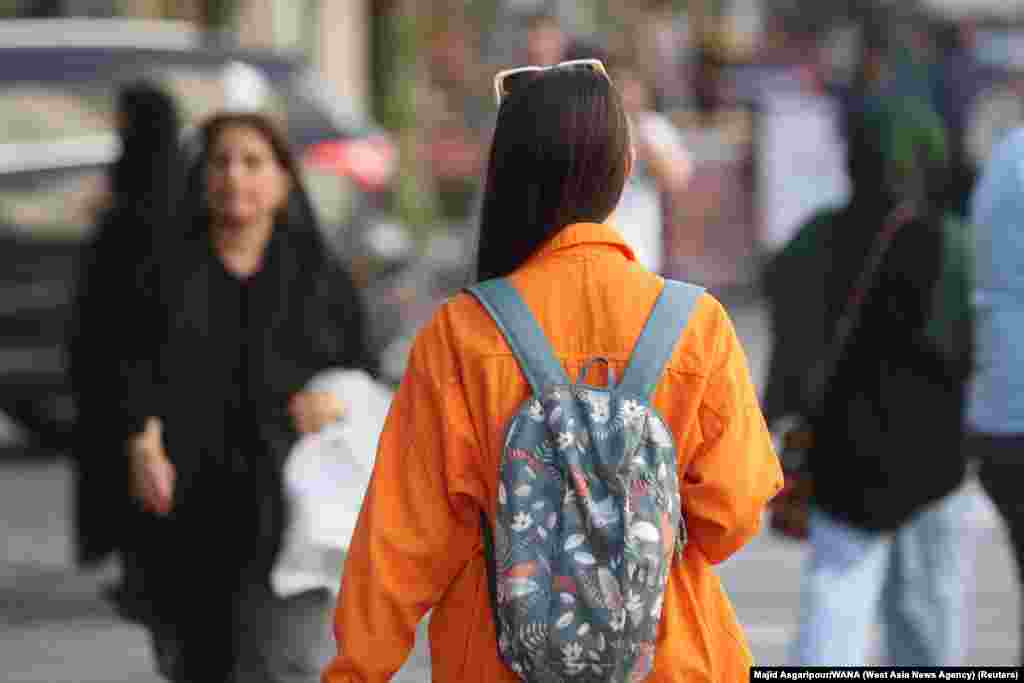 A woman goes without the mandatory hijab in Tehran on July 16. An Iranian official on July 16 confirmed that patrols of the notorious morality police, known officially as Guidance Patrols, have returned to Iran’s streets after months of keeping a low profile. The patrols enforce laws around clothing and behavior between the sexes. 