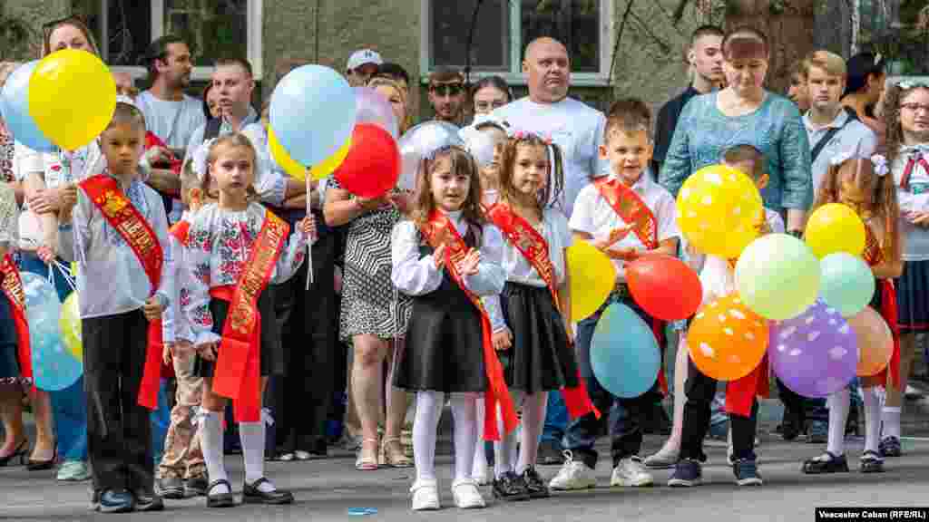 Moldovan children in traditional dress wait to enter the Tara Shevchenko school in Chisinau. Children across RFE/RL's region are welcoming the start of another year of learning.