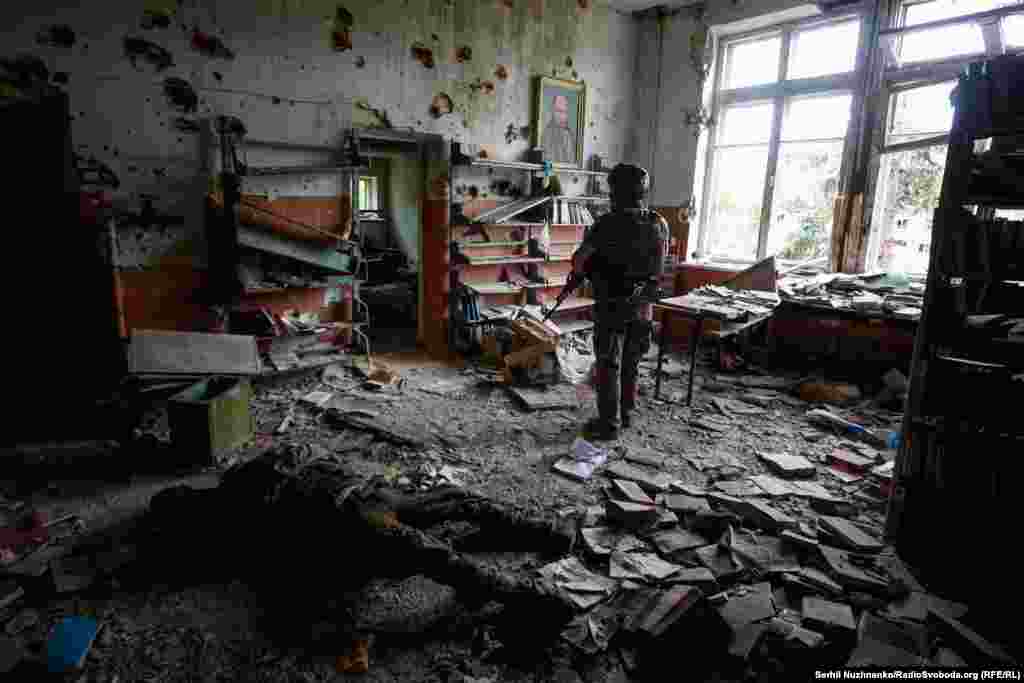 Ukrain harbysy Donetsk sebitindäki Blağodatnoýe obasynda bolan söweşde zeper çeken jaýyň içinde dur. 2023-nji ýylyň 17-nji iýuny