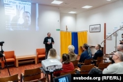 Vyachaslau Siuchyk speaks to visitors at the exhibition.