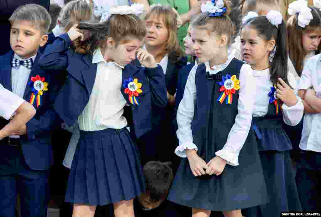 A little girl rubs her tired eyes during the first day at the lyceum named after Moldovan writer Gheorghe Asachi in Chisinau. 