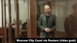 Russian opposition leader Vladimir Kara-Murza stands in the defendant's cage at the Moscow City Court on the final day of his trial, April 17, in which he was sentenced to 25 years in prison on charges of treason and spreading false information.