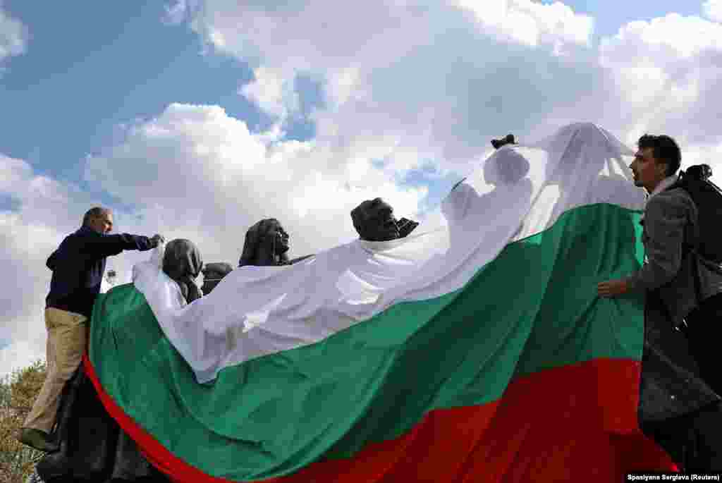 Activists wrap a Soviet sculptural ensemble in the Bulgarian flag on May 4, 2022. Public opinion in 2019, before the invasion of Ukraine, showed that more than two-thirds of Bulgarians saw communist-era monuments as important for Bulgaria's "national identity."