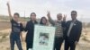 The family of Abolfazl Adinezadeh, a 17-year-old protester shot dead by Iranian security forces in October, stand by his grave on June 16.