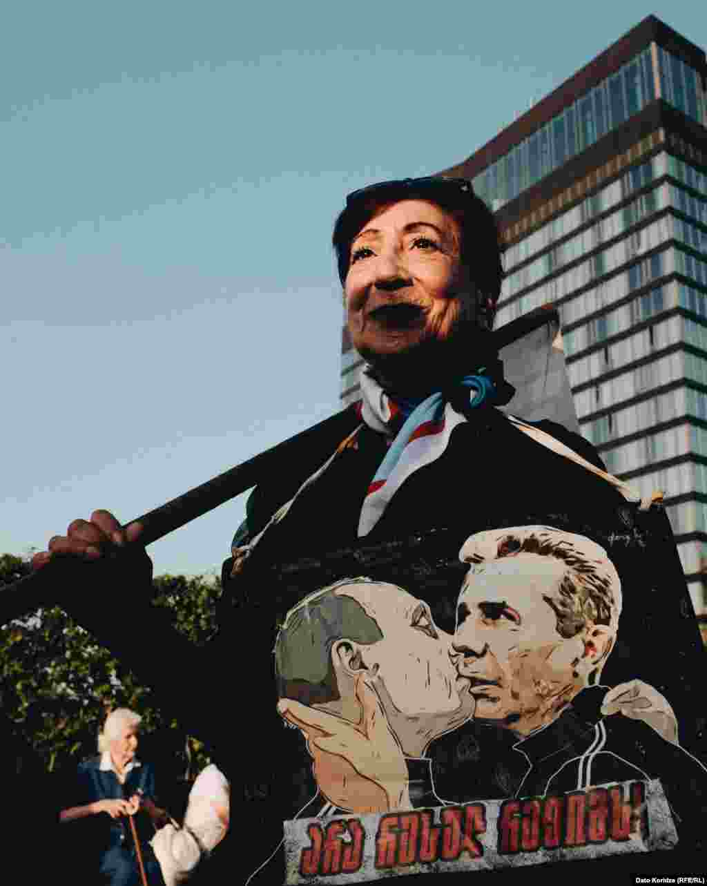 A woman attends the protest earlier in the day on April 28. Supporters of the bill say it mirrors similar U.S. legislation and promotes transparency. Opponents say the proposed legislation would stifle dissent and silence independent media. They have compared it to similar legislation in Russia, which is why many call it the "Russian law." 