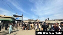 People wait to cross the Torkham border crossing between Afghanistan and Pakistan on February 24.