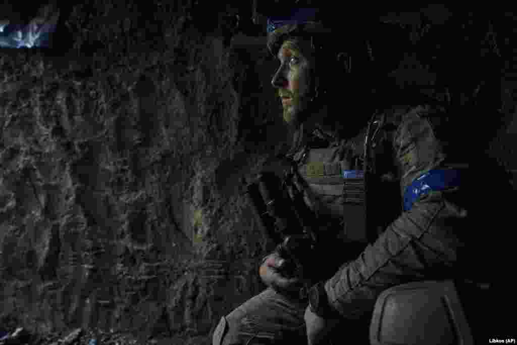Another soldier looks out of his trench position. 