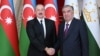 Azerbaijani President Ilham Aliyev (left) and Tajik President Emomali Rahmon shake hands in Dushanbe on September 14.
