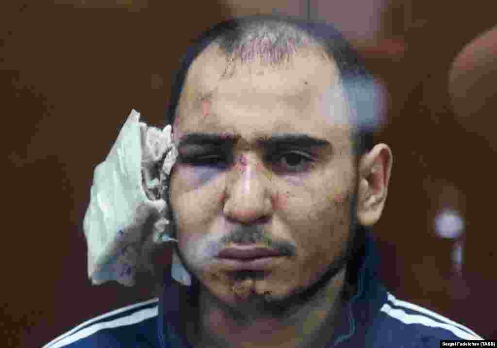 Rajabalizoda is seen at his March 24 court appearance with his right ear bandaged and showing evidence of being beaten while in detention. 
