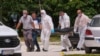 Police remove a body from the scene of an explosion in Cetinje on June 20.