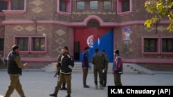 Police officers gather outside a police station in Warburton, an area of the Nankana district of Pakistan's eastern Punjab Province, on February 12. 