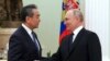 Russian President Vladimir Putin greets Chinese Communist Party's foreign policy chief Wang Yi during their meeting at the Kremlin on February 22. 
