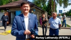 Duman Mukhammedkarim emerges after his release on May 26, just before being charged again.