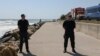 Members of the Inspectorate for Emergency Situations and the Internal Affairs Ministry stand guard near the cliff where an explosion occurred in Costinesti, Romania, on August 14.