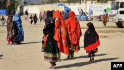 Afghan migrants arrive from Pakistan at the Afghanistan-Pakistan border in the Spin Boldak district of Afghanistan's Kandahar Province early last month.