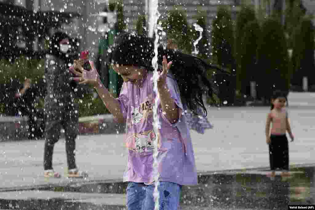 A young girl cools off in a water fountain at Tehran's Ebrahim Park as temperatures reached 38 degrees Celsius on August 1. State media reported temperatures had this week exceeded 51 degrees Celsius in the southern city of Ahvaz. 
