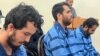 Rahmatollah Nouruzof (left), a Tajik national with admitted ties to Islamic State, sits in a courtroom with two other defendants on September 21.