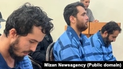 Rahmatollah Nouruzof (left), a Tajik national with admitted ties to Islamic State, sits in a courtroom with two other defendants on September 21.
