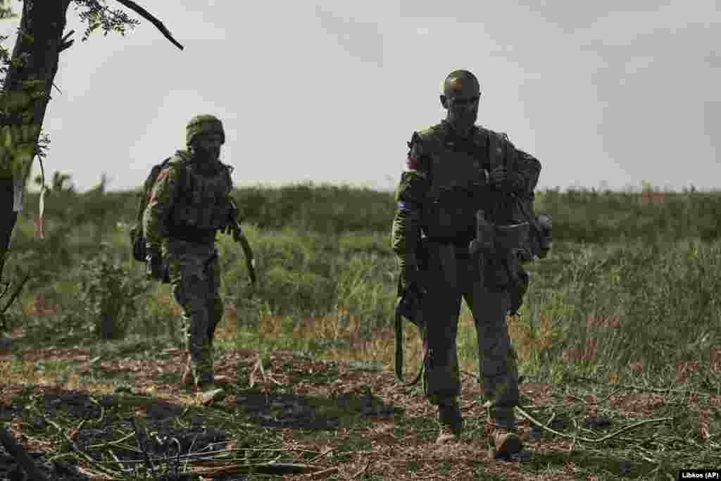 Ukrainian soldiers walk to their positions. Kyiv's forces in the southeastern Zaporizhzhya region have breached formidable Russian defensive obstacles, according to a U.S.-based research group.