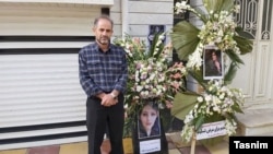 Mahsa Amini's father, Amjad, prepares for her funeral ceremony in September 2022.