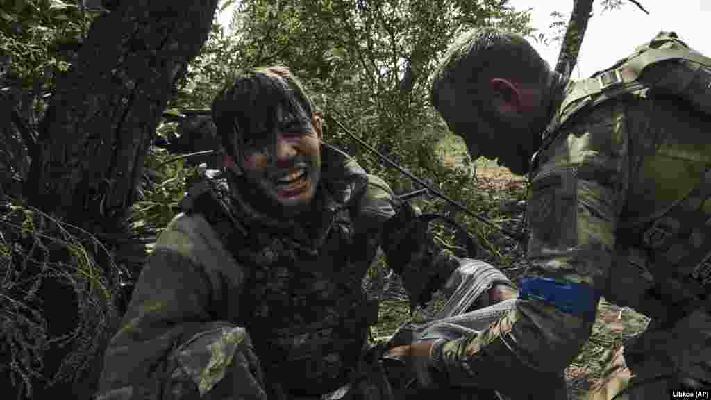 A Ukrainian soldier administers first aid to a wounded 19-year-old comrade on September 4. The unit was battling Russian forces near the eastern city of Bakhmut. The situation along the eastern front line remains difficult for Ukraine's troops as they defend and prevent the loss of strongholds, General Oleksandr Syrskiy, commander of Ukraine's ground forces, said on September 6.
