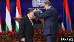Bosnian Serb leader Milorad Dodik (right) presents an award to Hungarian Prime Minister Viktor Orban in Banja Luka on April 5. 