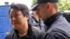 Do Kwon is escorted to court in Podgorica on May 11, 2023.