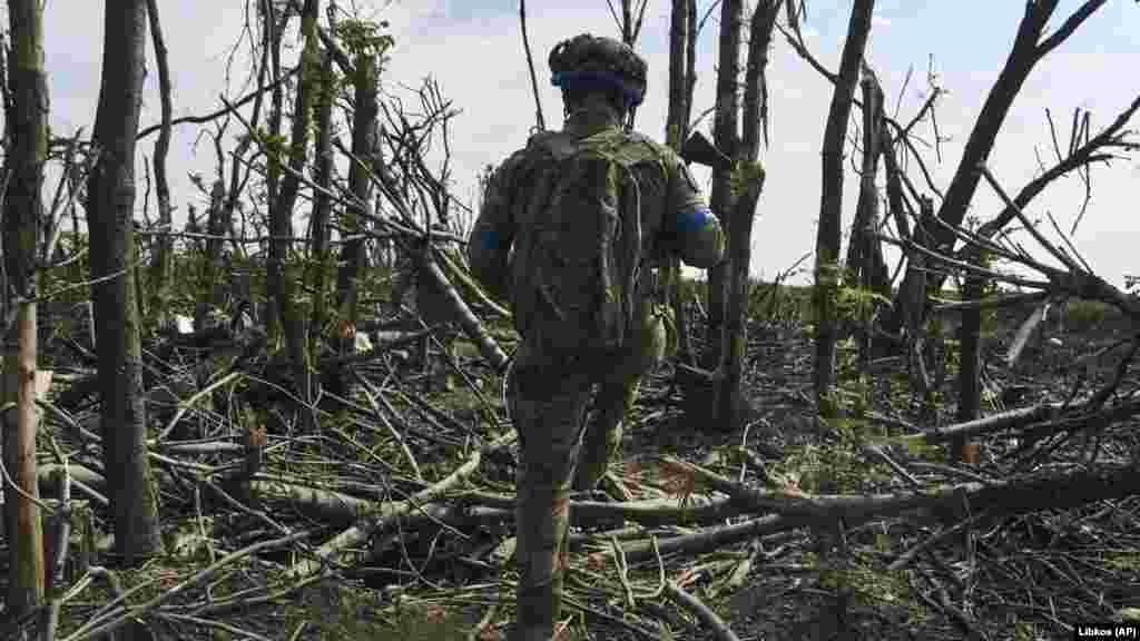 Amid the devastated landscape, a Ukrainian soldier makes his way toward a position. "The enemy does not abandon his plans to reach the borders of the Donetsk and Luhansk regions," General Syrskiy wrote on Telegram.