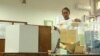 A woman casts her vote in repeat local elections in Belgrade on June 2
