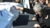 Iranian director Masoud Kimiaei grieves over the coffin of Dariush Mehrjui at the October 18 funeral for the filmmaker and his wife, who were stabbed to death over the weekend.