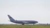The specially chartered plane departed after a six-hour delay, officials said.