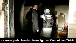 An Investigative Committee officer is seen at a storage facility and production site of counterfeit alcohol beverages in Russia's Orenburg region last month.