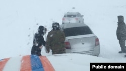 Rescue workers come to the aid of drivers stranded in Kazakhstan's Turkestan on January 3.