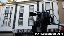 A news crew's camera is seen outside a house in Castrop-Rauxel, western Germany, where police arrested one of two Iranian brothers on suspicion of "having prepared a serious act of violence threatening the security of the state."