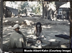 A "wandering ascetic," with his body coated in ash, and a companion in Lahore in today's Pakistan in 1914.