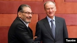 Ali Shamkhani, the secretary of the Security Council of Iran, shakes hands with his Russian counterpart, Nikolai Patrushev, on November 9. 
