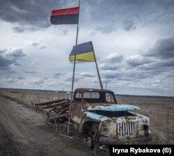 The Ukrainian flag and that of the Ukrainian Insurgent Army (left) photographed near the front lines of the fight between Ukrainian forces and Russia-backed separatists in 2019