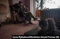 Two soldiers fly a drone from a position in a house at an unnamed location in October.