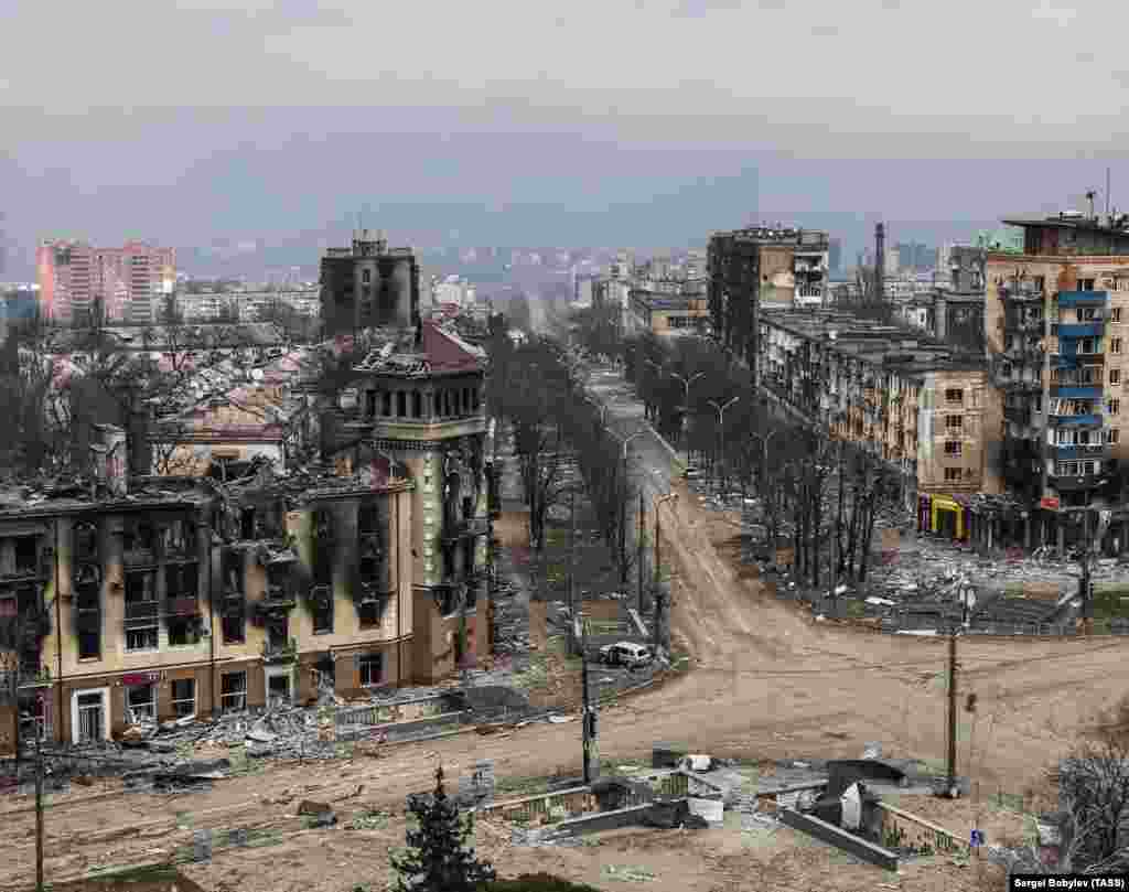 An aerial view of the crossroads and the same turreted building in April 2022. 