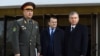 Uzbek President Shavkat Mirziyoev (right) with his chief of staff, Zainilobiddin Nizomiddinov (center), in 2020.