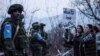Nagorno-Karabakh - Azerbaijani protesters stand in front of Russian peacekeepers on a road outside Stepanakert, December 24, 2022. 