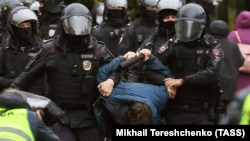 Russian police detain a protester who took part in a rally in Moscow against Putin's announced mobilization on September 21.