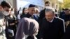 Uzbek President Shavkat Mirziyoev speaks with supporters at a polling station in Tashkent during the presidential election in October 2021.