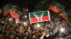 Supporters of Imran Khan's Tehrik-e Insaf (PTI) party wave flags and chant in support of the former prime minister at a rally in Peshawar on April 10.