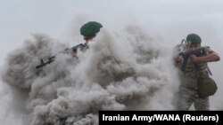 Members of the Iranian Army take part in an annual drill in the coastal area of the Gulf of Oman and near the Strait of Hormuz on December 30.