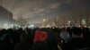 Protesters in Astana walk toward the city center on November 23, only to be stopped by police.